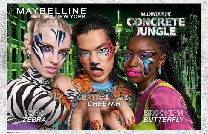 Three models showcase colorful makeup looks inspired by animals, set against an urban background for a Maybelline Halloween campaign.