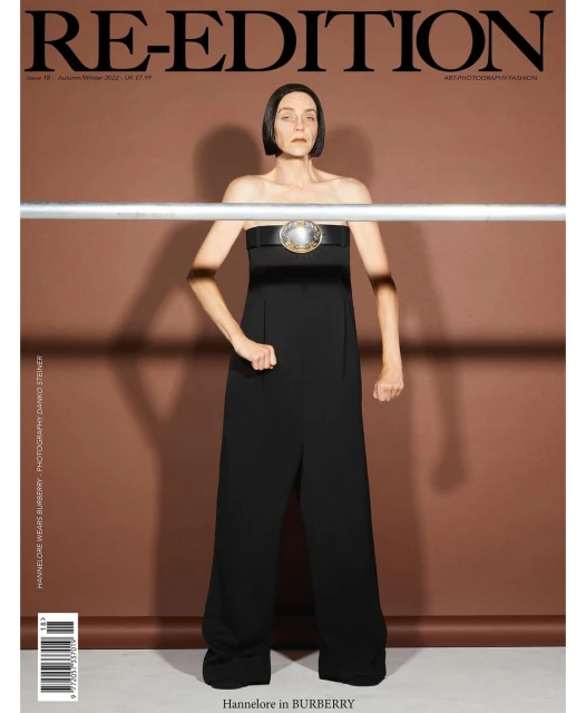 Magazine cover featuring a woman in a black jumpsuit with a statement belt against a neutral background, promoting the Re-Edition magazine.