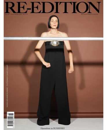 Magazine cover featuring a woman in a black jumpsuit with a statement belt against a neutral background, promoting the Re-Edition magazine.