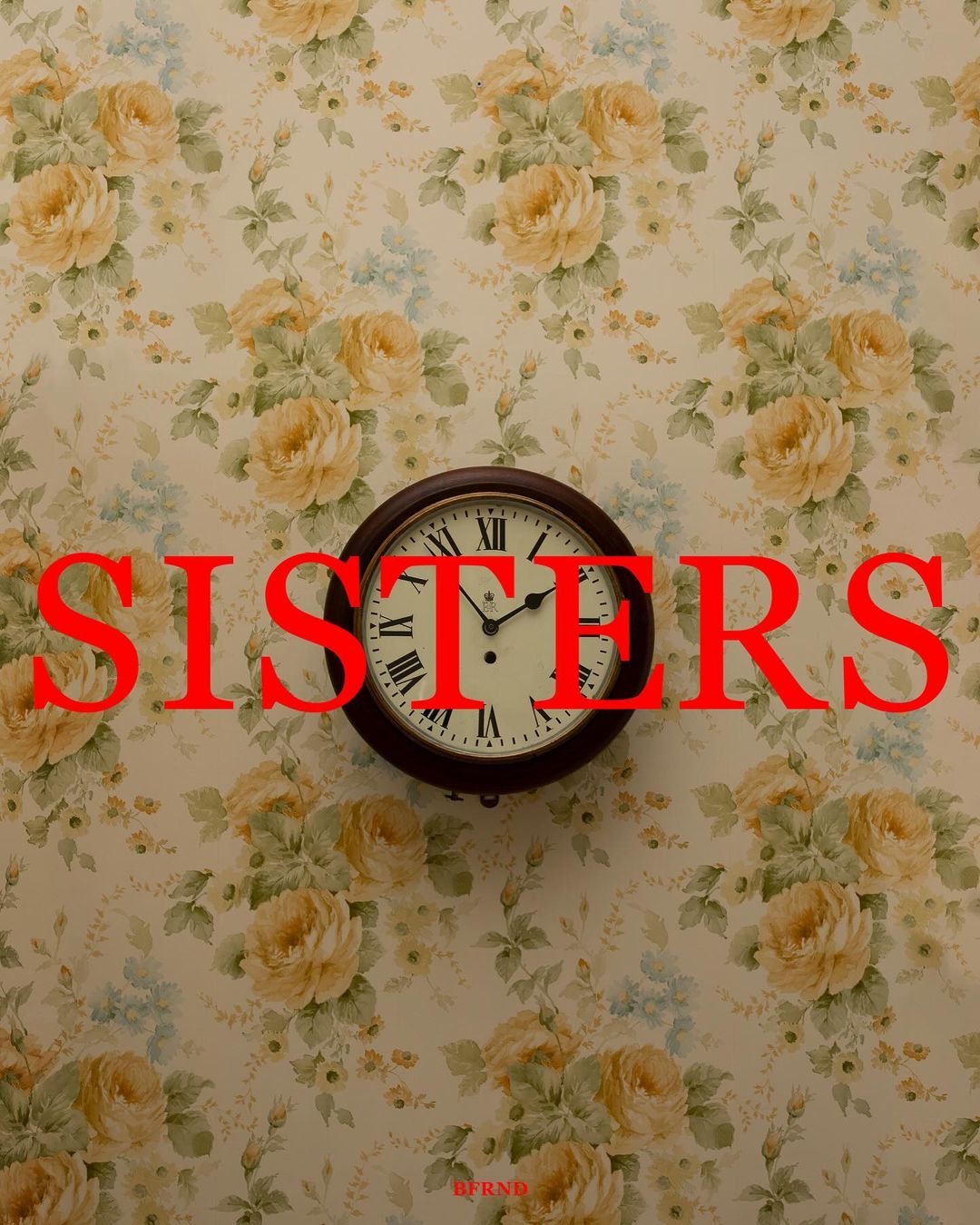 Floral wallpaper background with analog clock, bold red "SISTERS" text overlay. A retro styled image with prominent floral design.