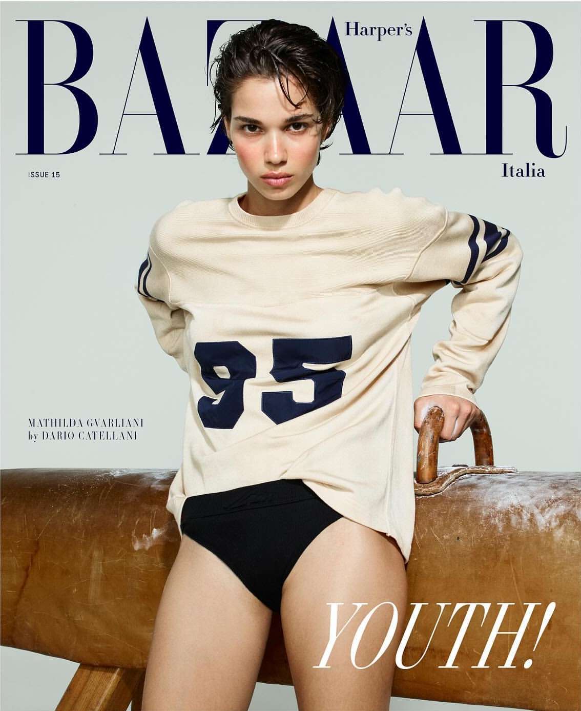 Fashion magazine cover featuring a young woman in sportswear-inspired attire, posing in a studio setting, with Harper's Bazaar Italia masthead.