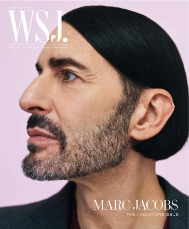 Profile portrait of Marc Jacobs with slicked-back dark hair and beard against a pale background for WSJ Magazine, shot by Dario Catellani