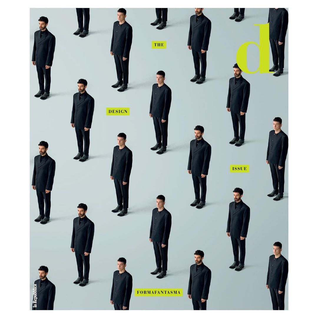Magazine cover featuring a grid of adult males in dark suits against a pale background, with yellow text elements.