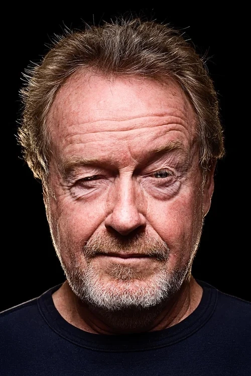 Close-up dramatic portrait of filmmaker Ridley Scott looking directly forward against a dark background.