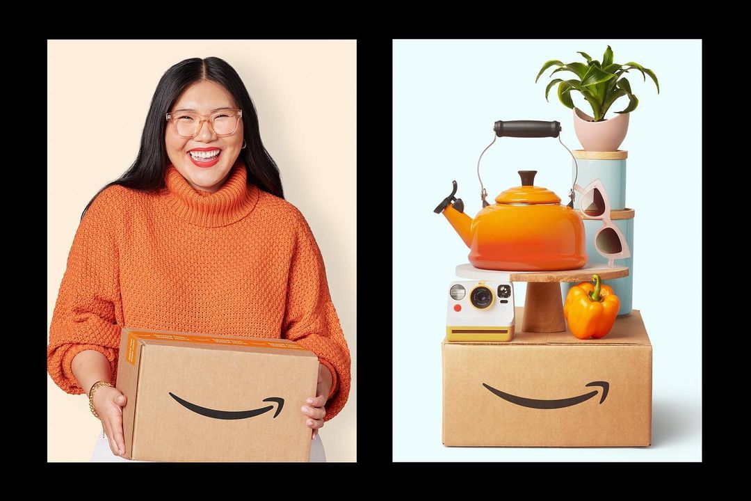 Smiling Asian woman in orange sweater holding Amazon delivery box; Still life with tea kettle, houseplant, vintage camera, and pepper.
