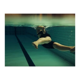 Underwater view of a swimmer in a tiled swimming pool captured by photographer Dave Imms.
