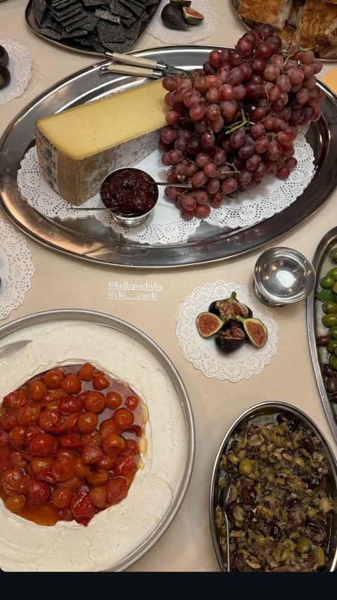 Overhead shot of cheese, grapes, and figs on trays, creating an appetizing food arrangement for a catered event or appetizer spread.