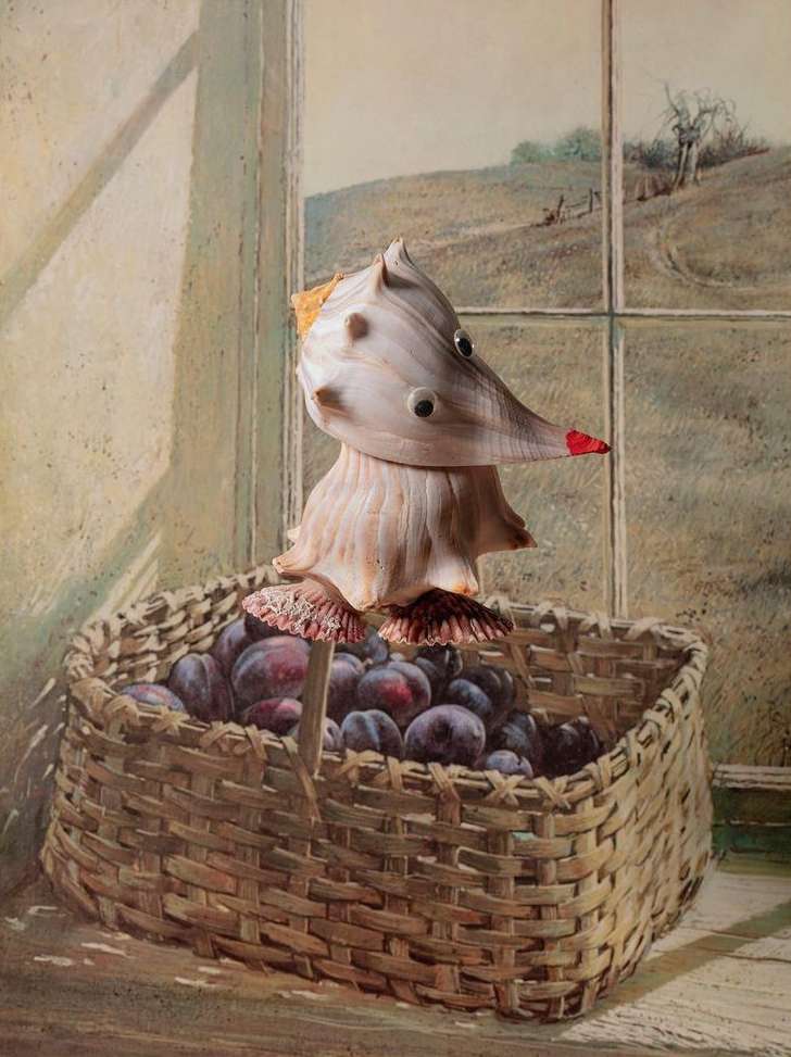 Still life art features a woven basket full of plums with a whimsical shell sculpture on top, set against a window and pastoral background.