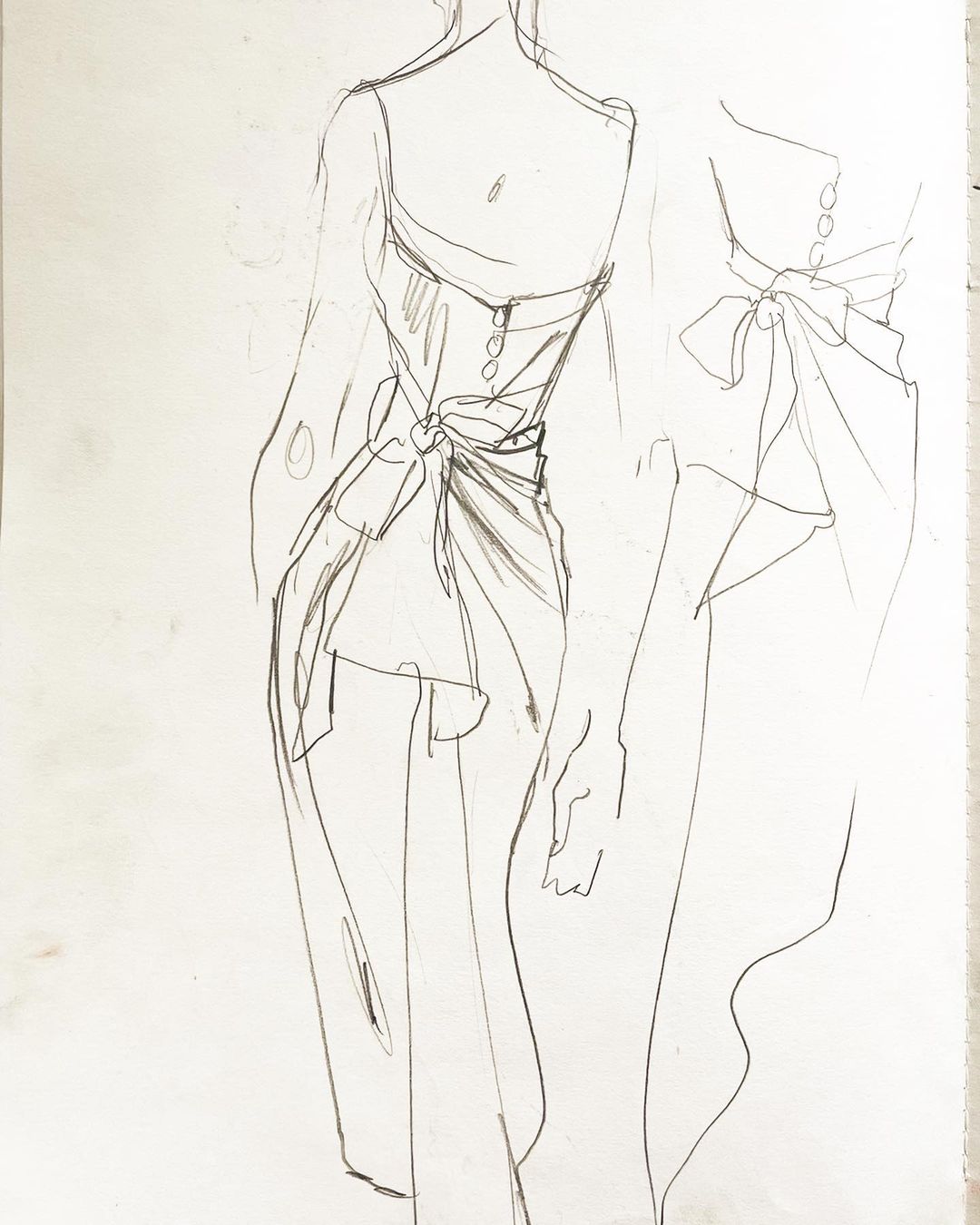 Fashion sketch featuring a woman in a dress with a bow, rendered in a delicate line art style on a textured paper background.