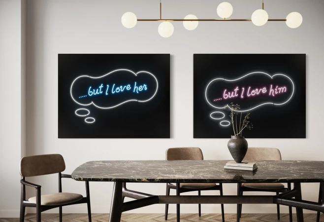 Two large dark art prints with glowing neon speech bubbles reading but I love her and but I love him hanging in a dining room