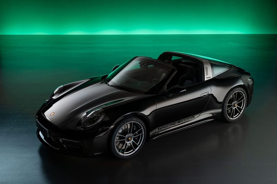 Sleek black Porsche Targa Design Edition car showcased in a studio setting with green gradient backdrop, highlighting its design and features.