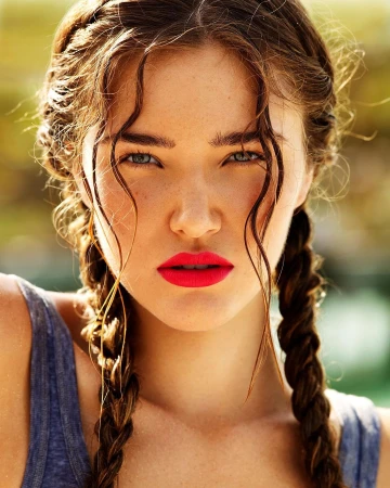 Close-up portrait of a young woman with braided hair and vibrant pink lipstick captured by photographer David Gubert