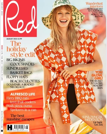 Magazine cover featuring a smiling model in a patterned outfit and hat, promoting summer fashion and travel, set against a bright outdoor backdrop.