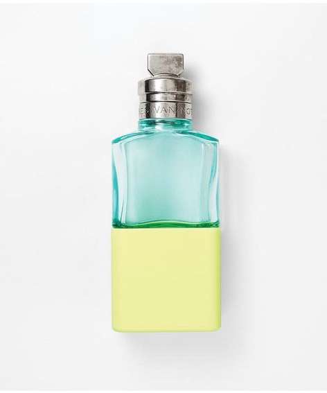 Turquoise and yellow perfume bottle on a white background. Square glass flacon with silver top. Minimalist, modern, and clean design.