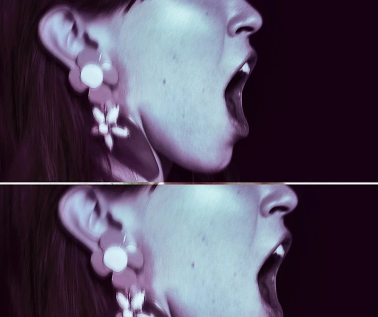 Close-up shot of a pale-skinned adult female with her mouth open, wearing flower earrings, set against a dark background.