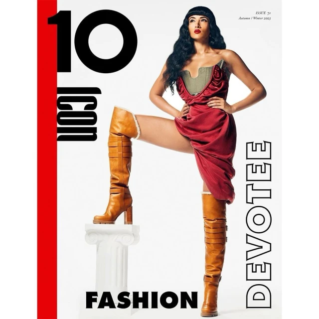 Fashion magazine cover featuring a female model in a red dress and thigh-high boots, posing on a white pillar against a white background.