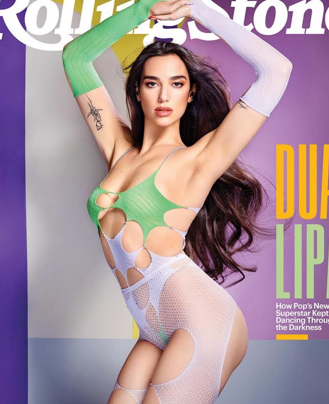 Dua Lipa poses on Rolling Stone cover in white mesh and cutout green top, arms raised, with text overlay on a gradient background.