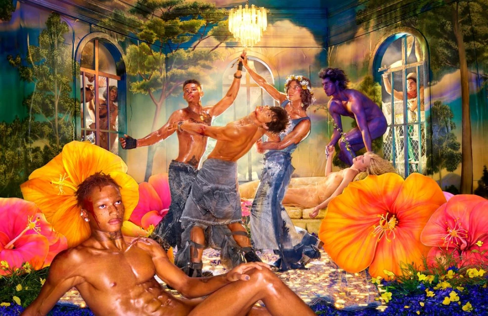 Artistic image featuring a group of nude and semi-nude young adults posing with lush flowers and painted skin indoors, lit by a chandelier.
