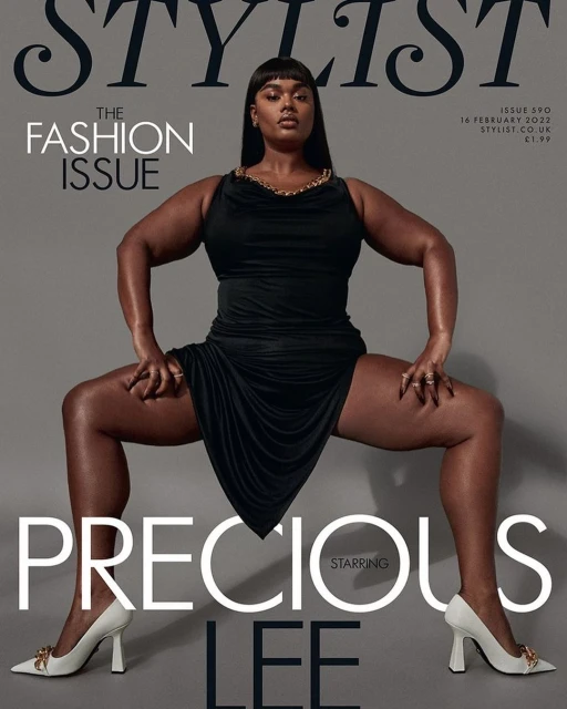 Magazine cover featuring Precious Lee in a black dress and white heels, posing with wide stance against a solid grey background. Fashion.