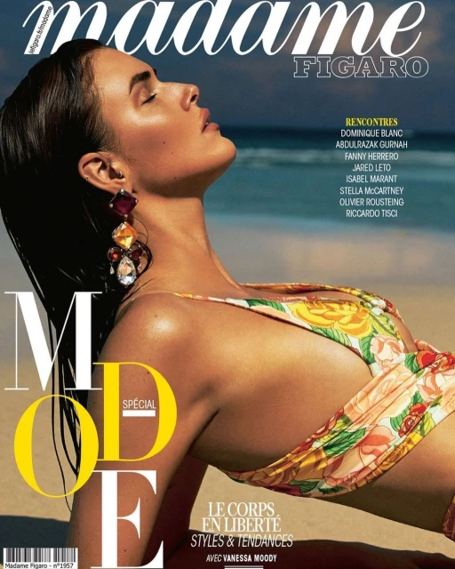 Magazine cover featuring a woman in floral bikini, wearing large earrings, with a beach background and magazine text overlays.