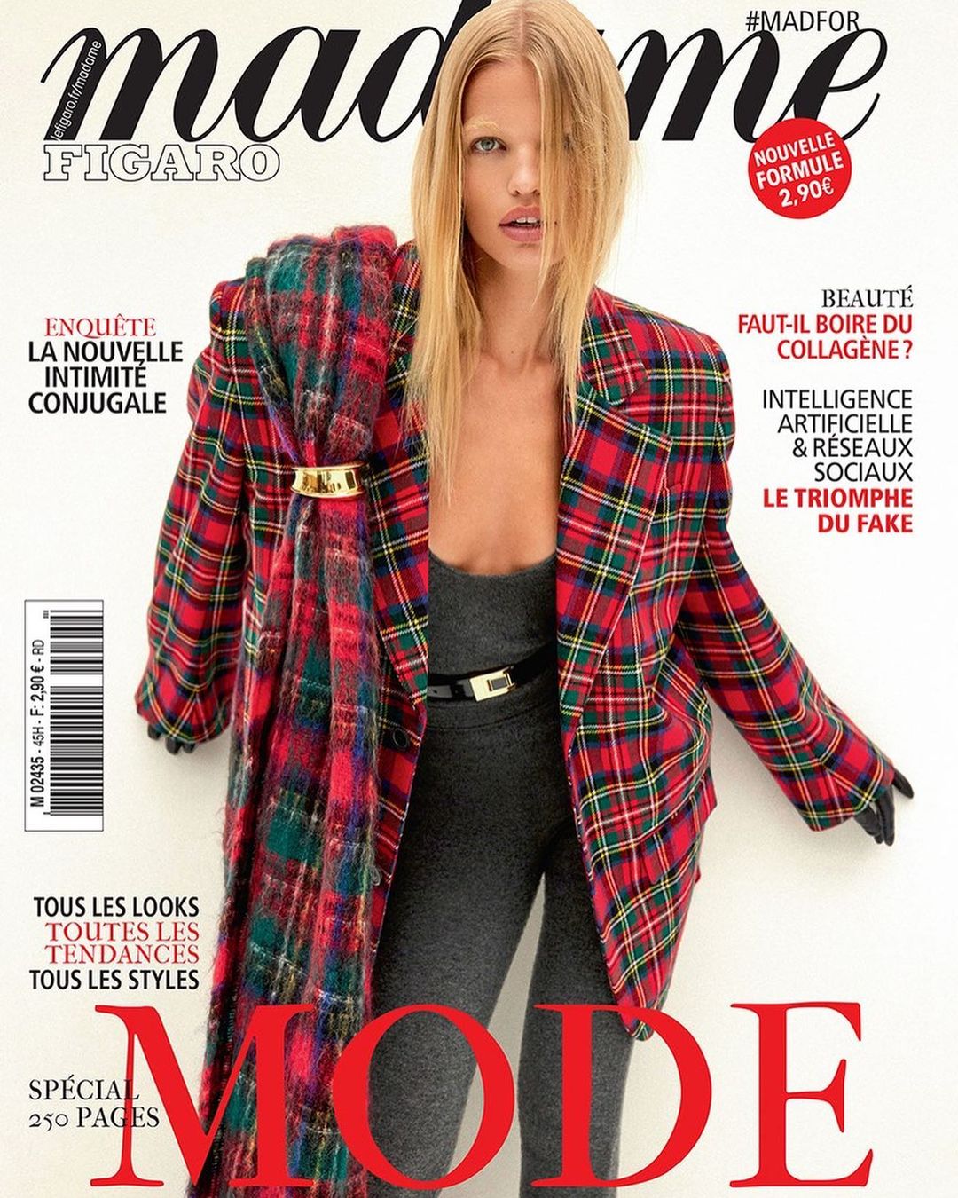 Magazine cover featuring a fair-skinned fashion model in a plaid blazer, gray top and leggings, a gold belt, and blonde hair.
