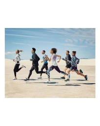 Group of six diverse runners in athletic apparel sprinting across a sandy desert landscape under a clear blue sky
