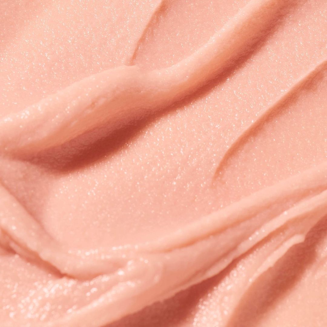 Close-up shot of textured pink cream with smooth and rippled surface. Ideal for beauty product presentations, cosmetic ads, or skincare ingredient visuals.