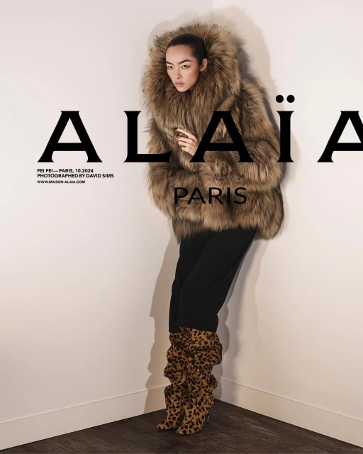 Fashion editorial featuring an Asian woman in a fur coat and animal-print boots, posing against a neutral corner with fashion brand text overlay.