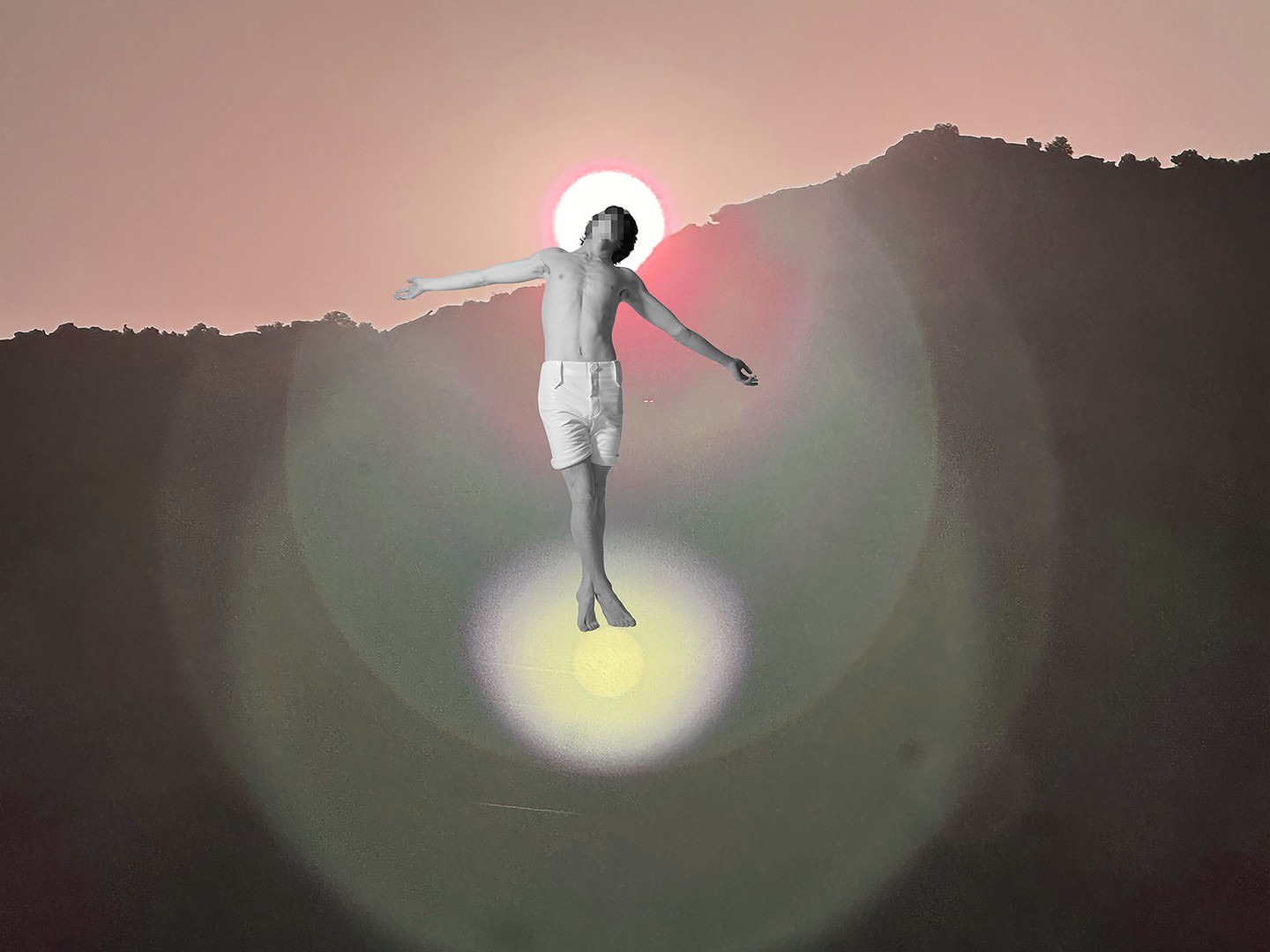 A shirtless young adult with outstretched arms appears to float against a backdrop of hills and a sunset-like sky with lens flare.