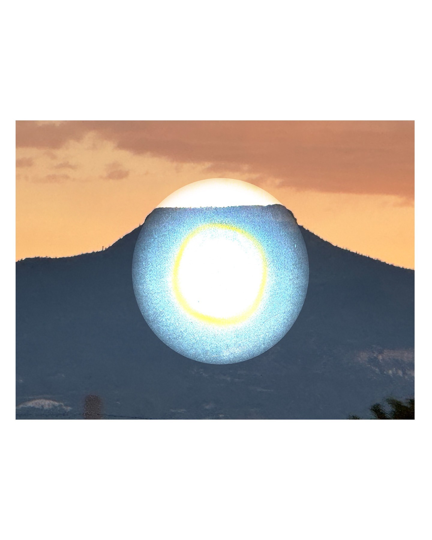Abstract landscape featuring a mountain range silhouette in the background and a digitally created, glowing blue orb hovering above the peak.