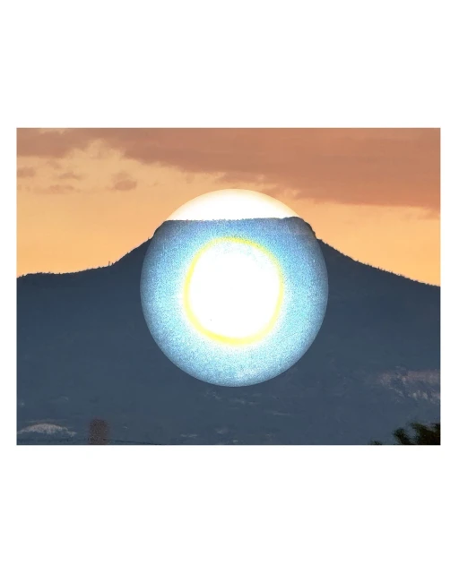 Abstract landscape featuring a mountain range silhouette in the background and a digitally created, glowing blue orb hovering above the peak.