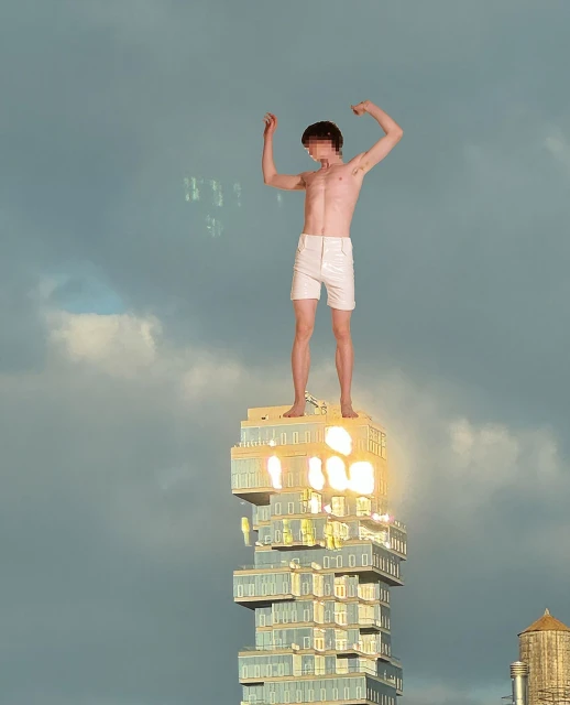 Man standing shirtless atop a skyscraper with arms raised against a cloudy sky; modern architecture and urban setting; golden sunlight highlights.