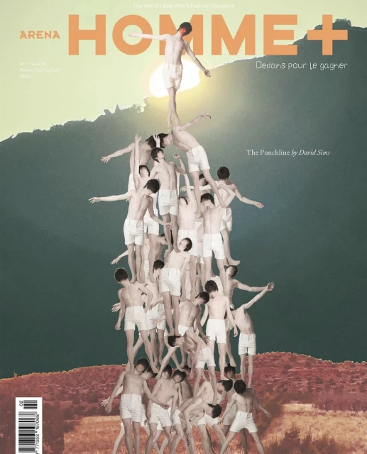 Editorial-style magazine cover shot of a human pyramid made up of shirtless young men, set against a mountain backdrop and cloudy sky.