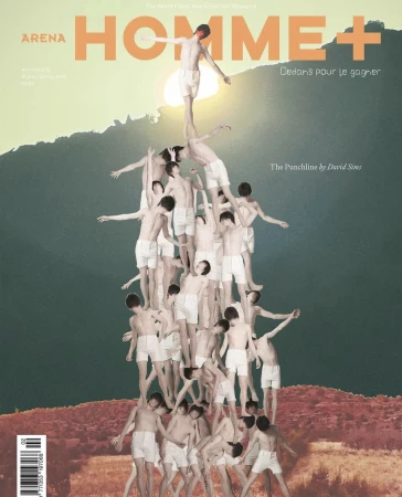 Editorial-style magazine cover shot of a human pyramid made up of shirtless young men, set against a mountain backdrop and cloudy sky.