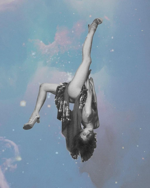 Woman in shimmery skirt and heels poses upside down against a celestial background with blue, pink, and white hues and star accents.