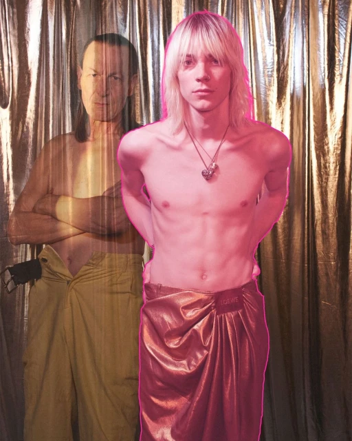 Two men in front of a textured backdrop. One man stands in the foreground in a wrap skirt, while the other is superimposed behind.