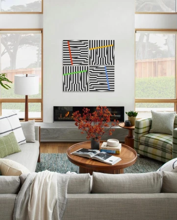 Living room featuring modern art with geometric patterns in black and white with colored vertical stripes above a fireplace.