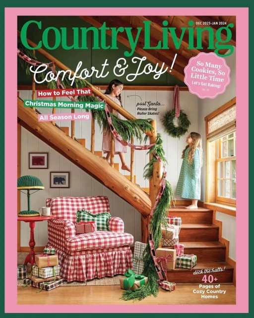 Country Living magazine cover with two girls on a log staircase, Christmas decorations, gifts, and a plaid armchair.