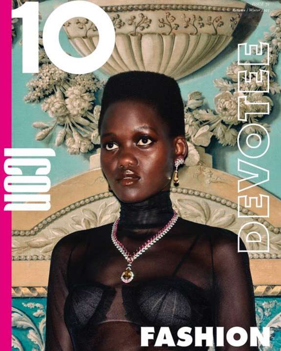 Magazine cover featuring a dark-skinned woman wearing jewelry, posing in front of an ornate floral background with graphic text overlay.