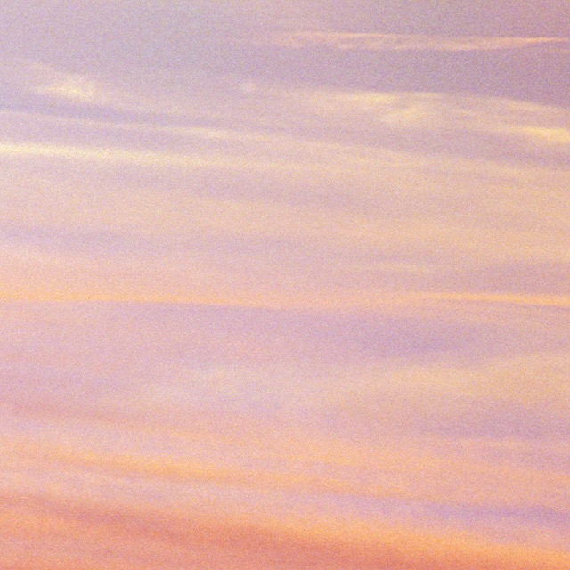Pastel sky background with layers of light pink and yellow clouds creating a soft, dreamy atmosphere at dusk or dawn.