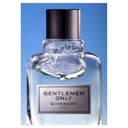 Close-up product shot of a glass perfume bottle with a black cap against a gradient blue background