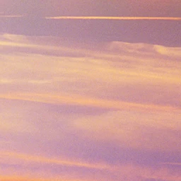 Soft pink and orange sunset clouds filling the sky with horizontal light layers captured in Paris.