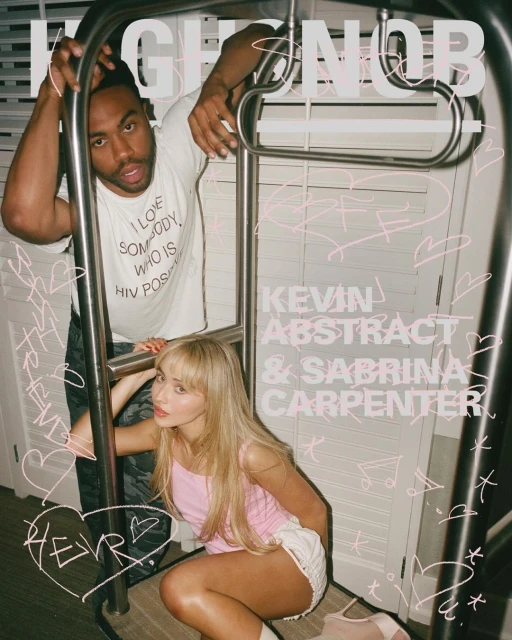 Sabrina Carpenter and Kevin Abstract pose with a metal luggage rack in an indoor setting, showcasing a casual and candid aesthetic.