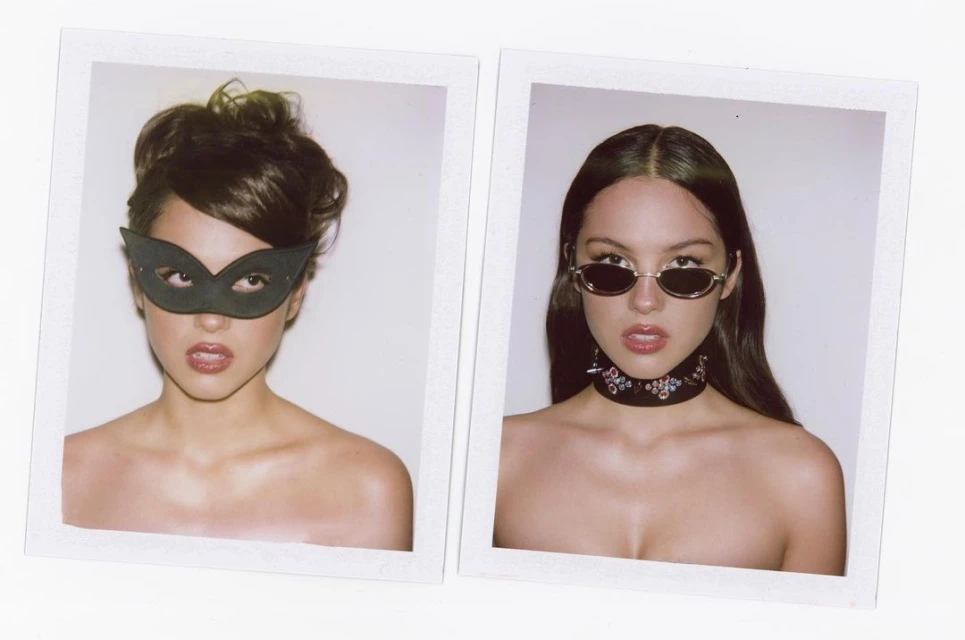 Two portraits of woman: one wearing a black mask, the other in sunglasses with a patterned choker, both against a stark white background.