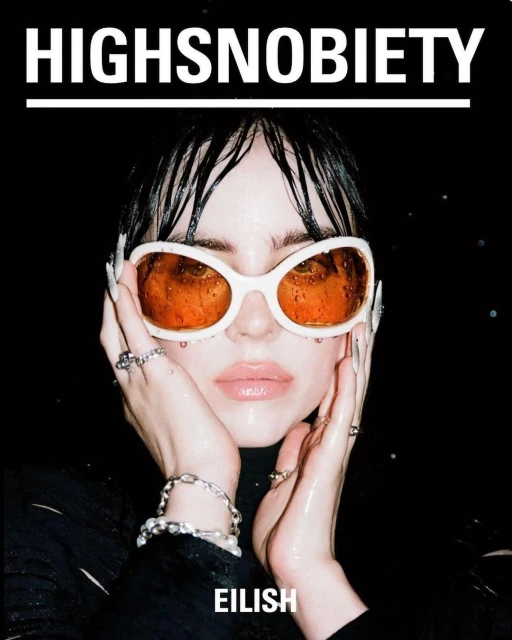 Close-up fashion magazine cover featuring a young woman with wet hair, wearing sunglasses, and jewelry against a black background.