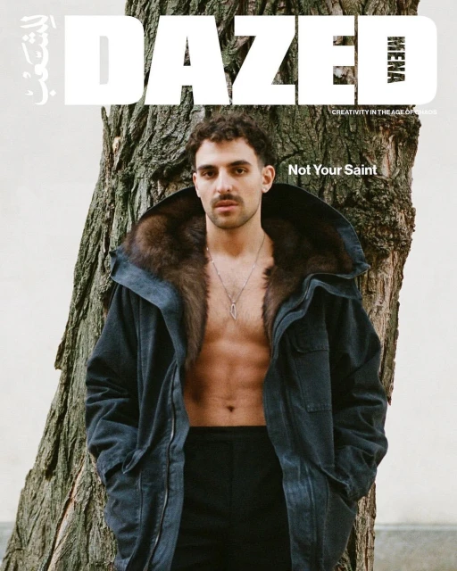 Dazed magazine cover featuring a male model with a fur-lined coat standing next to a tree in a medium shot.