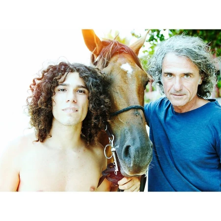 Portrait of two men standing outdoors with a brown horse by photographer Dean Freeman.
