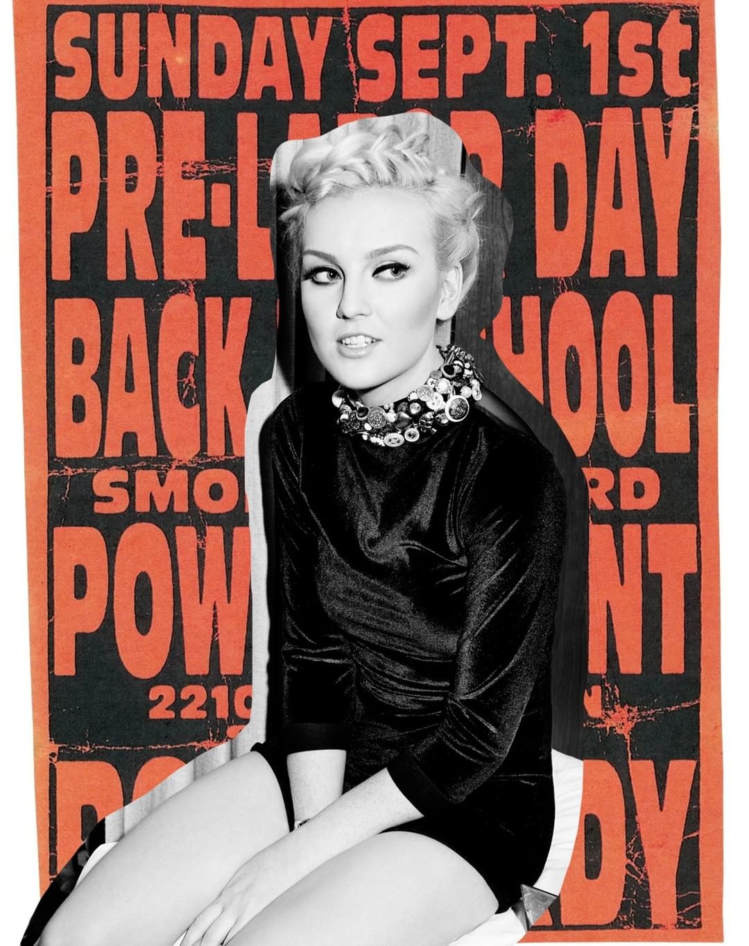 A fair-skinned woman with blonde hair wears a black velvet dress and jeweled collar necklace in front of an orange graphic poster.
