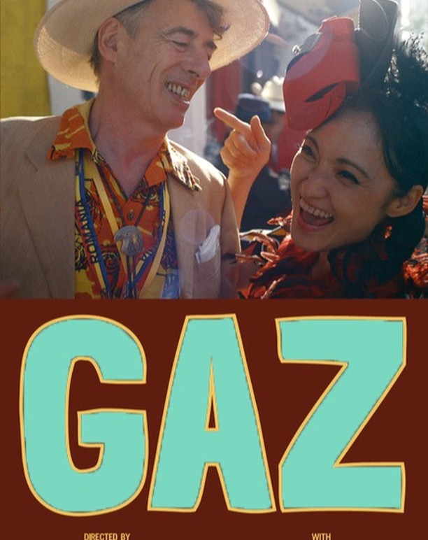 Movie poster featuring a man in a hat pointing and a smiling woman, with 'GAZ' text displayed prominently in teal with a brown outline.