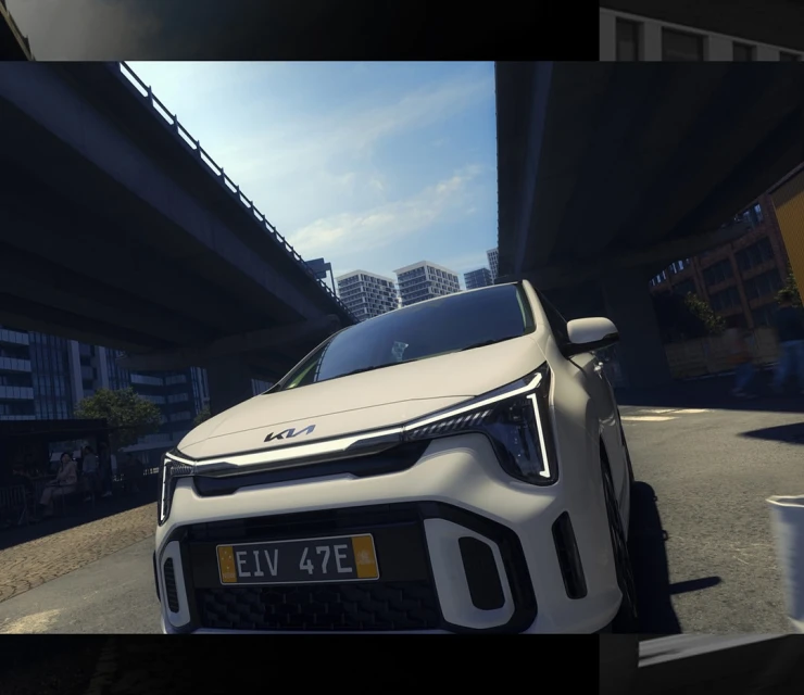 White Kia Niro electric car parked under an overpass in a city setting on a sunny day, showcasing its modern design and urban environment.